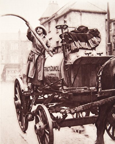 An Irish sportswoman working a watering-cart: Miss M. K. McVeagh, at Finchley by English Photographer